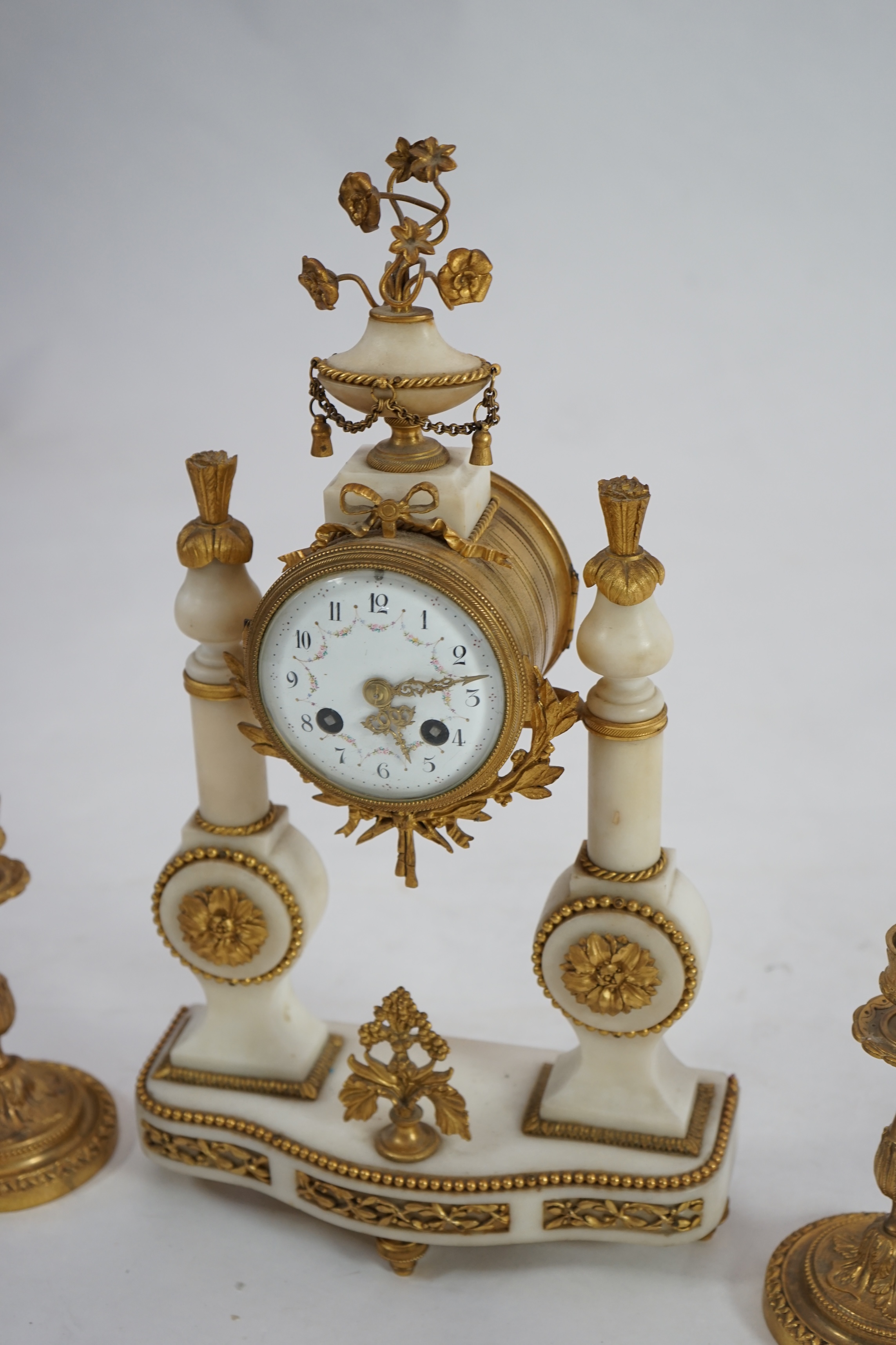 An early 20th century French ormolu mounted white mounted portico clock